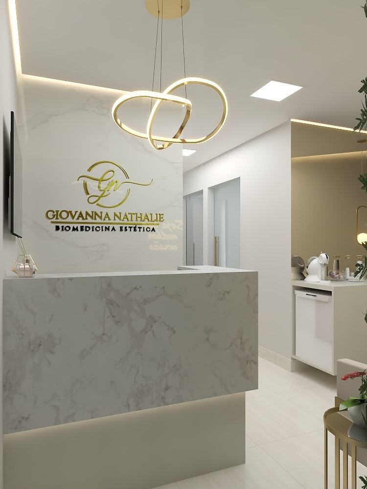 Recepção da Estética Giovanna Nathalie: logo em dourado sobre parede de mármore